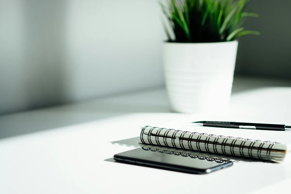 A notebook, pen and phone ready for recording inspection questions
