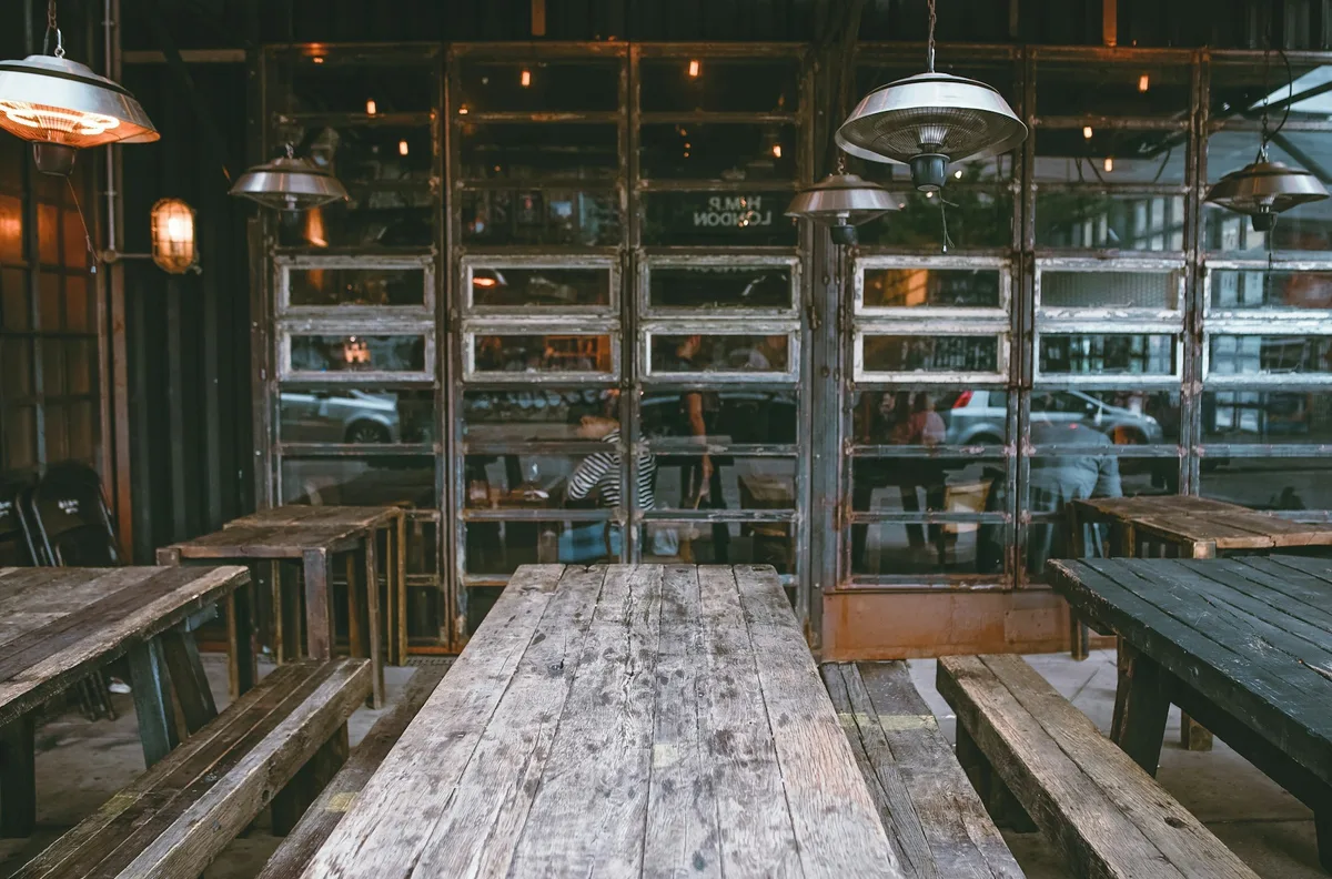 Wooden tables and benches on a restaurant terrace